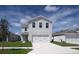 Two-story house with a two-car garage and well-maintained lawn at 5031 Starboard St, Haines City, FL 33844