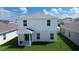 Two story house with covered patio and grassy backyard at 5031 Starboard St, Haines City, FL 33844