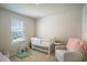 Bright Bedroom with crib, armchair, and window at 5031 Starboard St, Haines City, FL 33844