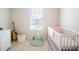 Bedroom featuring crib, guitar, and ample natural light at 5031 Starboard St, Haines City, FL 33844