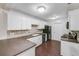 Kitchen with white cabinets, dark countertops, and black appliances at 3050 Cross Fox Dr, Mulberry, FL 33860