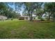 Spacious backyard with mature trees and large grassy area at 3050 Cross Fox Dr, Mulberry, FL 33860