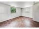 Simple bedroom with dark brown tile floors and two windows at 3050 Cross Fox Dr, Mulberry, FL 33860