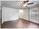 Living room with dark brown tile floors and a window with curtains at 3050 Cross Fox Dr, Mulberry, FL 33860