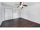 Spacious bedroom with dark brown tile floors and double closets at 3050 Cross Fox Dr, Mulberry, FL 33860