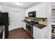 Kitchen with white cabinets, stone backsplash, and stainless steel appliances at 3050 Cross Fox Dr, Mulberry, FL 33860