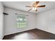 Well-lit bedroom with dark brown tile floors and a window with blinds at 3050 Cross Fox Dr, Mulberry, FL 33860