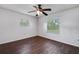 Bedroom with dark brown tile floors and two windows at 3050 Cross Fox Dr, Mulberry, FL 33860