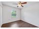 Bright bedroom with dark brown tile floors and a window with blinds at 3050 Cross Fox Dr, Mulberry, FL 33860