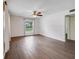 Living room with dark brown tile floors and window with curtains at 3050 Cross Fox Dr, Mulberry, FL 33860
