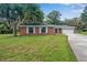 Brick ranch home with a two-car garage and spacious lawn at 3050 Cross Fox Dr, Mulberry, FL 33860