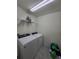Laundry room with washer, dryer, and ample shelving at 1036 Mattie Pointe Way, Auburndale, FL 33823