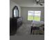 Main bedroom with dresser, large window, and bed at 1036 Mattie Pointe Way, Auburndale, FL 33823