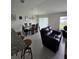 Combined dining and living area with seating for six at 1036 Mattie Pointe Way, Auburndale, FL 33823