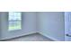 Well-lit bedroom with carpeted floor and window at 1476 Leamington Lane, Winter Haven, FL 33884