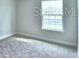 Cozy bedroom with carpeted floor and a window at 1476 Leamington Lane, Winter Haven, FL 33884