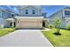 Two-story house with attached garage and landscaped yard at 1476 Leamington Lane, Winter Haven, FL 33884