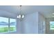 Bright dining room with large windows and chandelier at 1476 Leamington Lane, Winter Haven, FL 33884