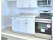 White kitchen cabinets, stainless steel appliances and granite countertops at 1476 Leamington Lane, Winter Haven, FL 33884