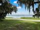 Scenic lakefront property with lush landscaping and a tranquil atmosphere at 405 W 4Th Ct, Frostproof, FL 33843