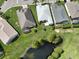 Aerial view of houses near a pond at 4104 Martindale Loop, Winter Haven, FL 33884