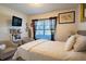 Cozy bedroom with a comfortable bed, sitting area, and ample natural light at 822 Sheen Cir, Haines City, FL 33844