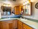 Double sink bathroom vanity with wood cabinets at 4822 Melody Ln, Lakeland, FL 33805
