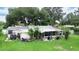 Features a home's backyard with a screened patio and landscaping at 4822 Melody Ln, Lakeland, FL 33805