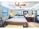 Main bedroom with king bed, ceiling fan and mirrored closet at 4822 Melody Ln, Lakeland, FL 33805