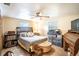 Spacious bedroom with a king-size bed, ceiling fan, and ample storage at 4822 Melody Ln, Lakeland, FL 33805