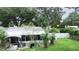 Backyard view showing a home with a screened enclosure and landscaping at 4822 Melody Ln, Lakeland, FL 33805
