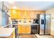 Bright kitchen features wood cabinets, stainless steel appliances, and an island at 4822 Melody Ln, Lakeland, FL 33805