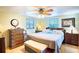 Main bedroom features a king bed, ceiling fan, and large windows at 4822 Melody Ln, Lakeland, FL 33805