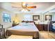 Main bedroom with king bed, ceiling fan and mirrored closet at 4822 Melody Ln, Lakeland, FL 33805