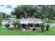 Home's backyard features a screened patio, lush landscaping, and a gazebo at 4822 Melody Ln, Lakeland, FL 33805
