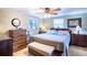 Main bedroom with king-size bed, ceiling fan, and built-in shelving at 4822 Melody Ln, Lakeland, FL 33805