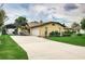 Single-story home with a large driveway at 926 Van Dr, Auburndale, FL 33823