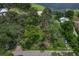 Aerial view of property highlighting its waterfront location and surrounding trees at 3038 Spirit Lake Dr, Winter Haven, FL 33880