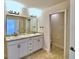 Double vanity bathroom with granite countertops and a separate toilet area at 1480 Leamington Lane, Winter Haven, FL 33884