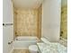 Well-lit bathroom with a bathtub and tile flooring at 1480 Leamington Lane, Winter Haven, FL 33884