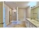 Bathroom with double vanity, walk-in shower, and garden tub at 1480 Leamington Lane, Winter Haven, FL 33884
