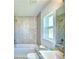 Modern bathroom with a bathtub and double vanity at 1560 Leamington Lane, Winter Haven, FL 33884
