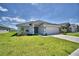 Single-story home with a two-car garage and well-manicured lawn at 1560 Leamington Lane, Winter Haven, FL 33884
