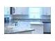 Modern kitchen with white cabinets and countertops at 1560 Leamington Lane, Winter Haven, FL 33884