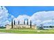 Community entrance sign with landscaping and playground visible at 1560 Leamington Lane, Winter Haven, FL 33884