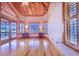 Bedroom with wood floors, access to deck, and plantation shutters at 29 Turtle Ln, Haines City, FL 33844