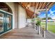 Long wooden front porch with double doors and a lantern at 29 Turtle Ln, Haines City, FL 33844