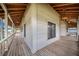 Corner view of a spacious covered porch with wooden flooring at 29 Turtle Ln, Haines City, FL 33844