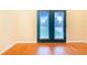 Room with hardwood floors and double doors leading outside at 29 Turtle Ln, Haines City, FL 33844