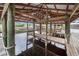 Covered boat lift with wooden dock and water access at 29 Turtle Ln, Haines City, FL 33844